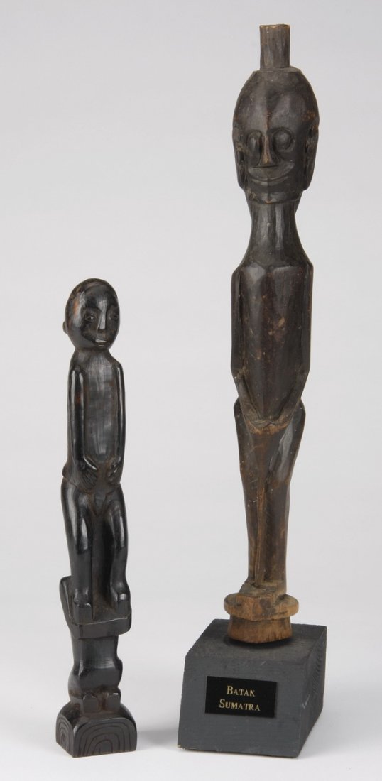 (2) Oceanic figural sculptures: Two Oceanic figural sculptures, hand carved wood of simplistic form, includes: (1) from Trobriand Islands, Papua New Guinea, 9.25"h x 1.25"w x 1.25"d, and (1) from Batak Sumatra, Indonesia, overall si