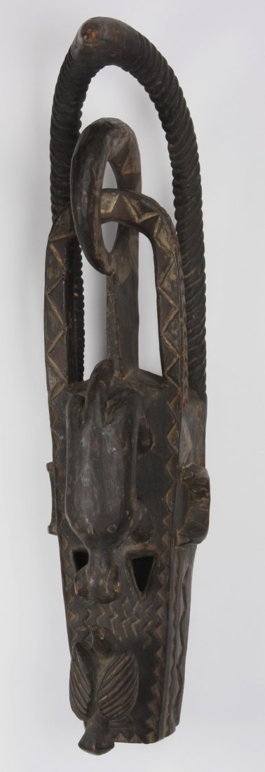 Bambara helmet mask, Mali: Bambara helmet mask, for the all-male Kòmò society, Mali, worn atop the head by a masquerader, an insignia of the knowledge and power that the organization engenders, of carved wood with geometric m
