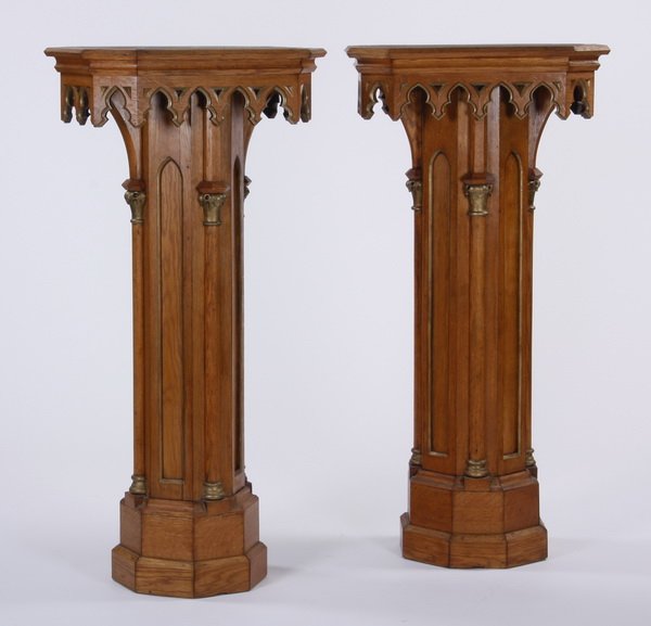 (2) 59"h Gothic Revival style pedestals: Pair of early 20th century Gothic Revival style octagonal pedestals, with a molded cornice top trimmed with trefoils over faceted columns interspaced by Gothic style arches, 59"h x 29.5"w x 19"d.