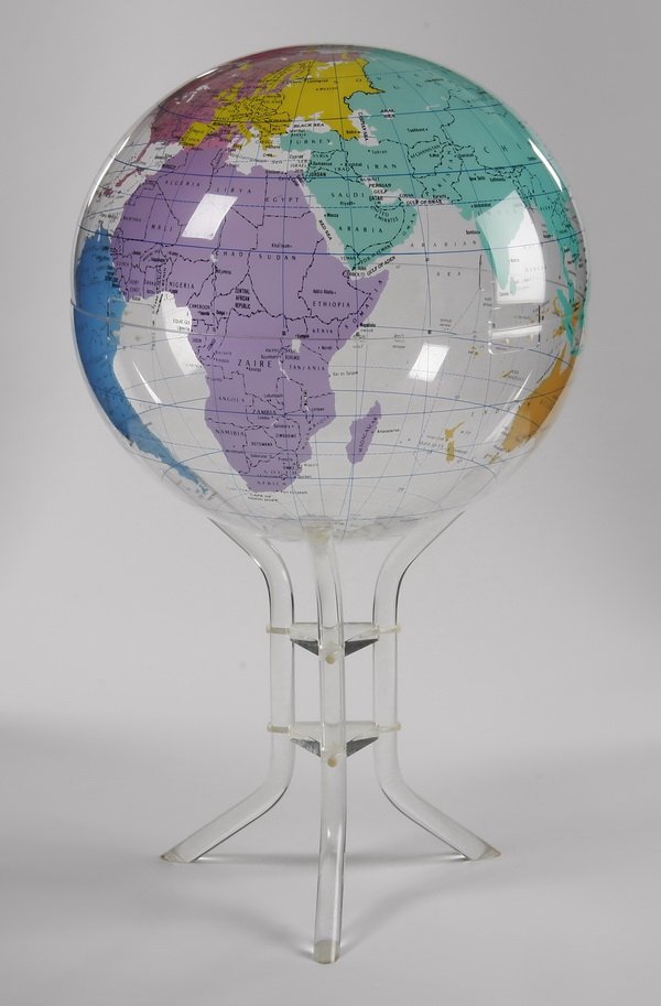 50"h acrylic floor globe on stand: Oversized 20th century acrylic floor globe and tripod base, with polychrome designs against a clear ground, 50"h x 32" diameter.