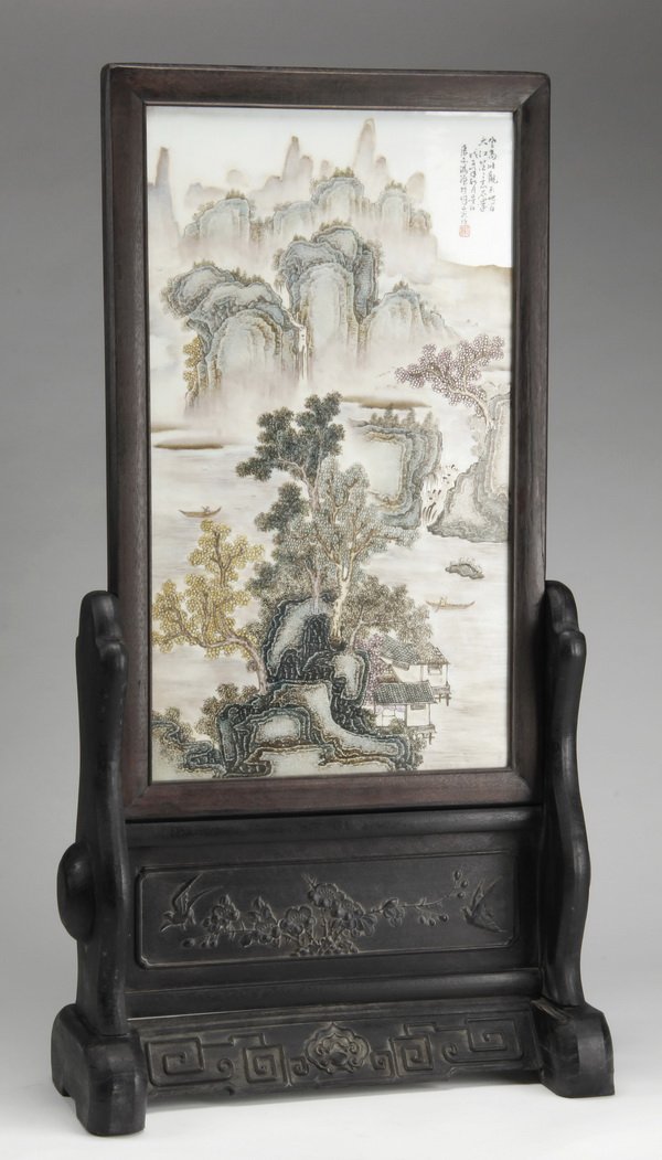 Early 20th c. Chinese porcelain, zitan screen: Early 20th century Chinese famille rose porcelain tabletop screen, hand decorated with a mountainous riverscape and inscribed upper right, framed and raised on a zitan wood stand relief carved with ch