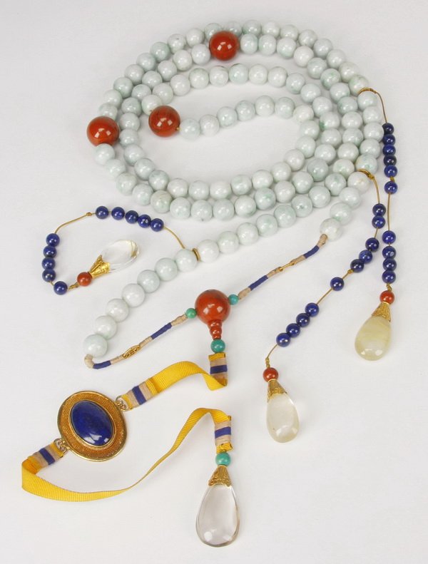 19th c. Chinese chao zhu court necklace: 19th century Chinese chao zhu court necklace, comprised of 108 jadeite beads divided by four larger carnelian agate beads, the central jiezhu with a yellow ribbon leading to a cabochon lapis lazuli pe