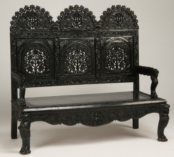 Early 20th c. carved Burmese settee: Early to mid 20th century Burmese pierce carved and ebonized arched back settee, 48"h x 56"l x 23"d.