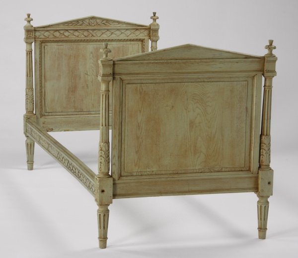 Early 20th c. French daybed: Early 20th century Louis XVI style paint decorated daybed with a relief carved pediment crest on the headboard and footboard, all raised on fluted tapering legs, 40"h x 72"l x 34"w.