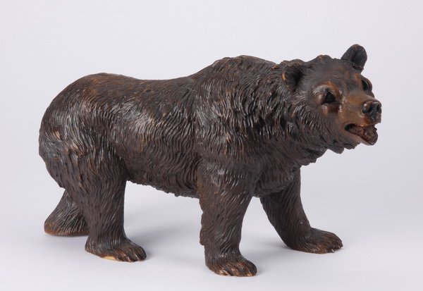 Early 20th c. Black Forest carved bear: Early 20th century Black Forest carved model of a strolling bear, with glass eyes, 7.5"h x 11"l x 5"w.