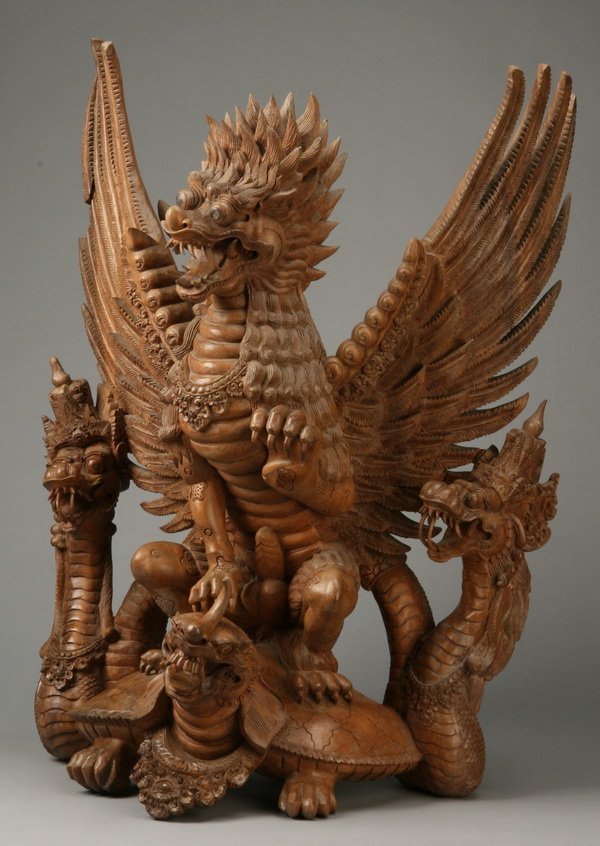 Indonesian carved sculpture of a dragon: Intricately carved Indonesian figural wood sculpture of a fierce dragon, 31.5"h x 24"w.