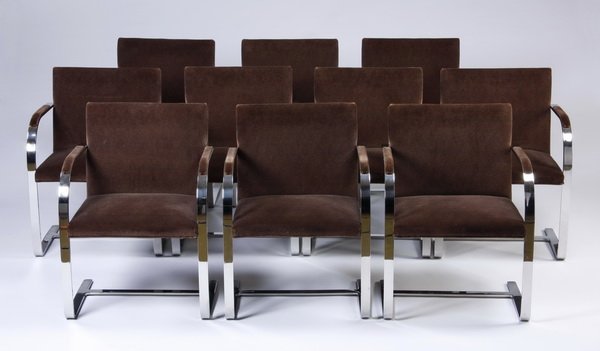 (10) Stainless steel armchairs by Brueton: Set of ten stainless steel Brueton Tubular Chairs, after the BRNO chair designed by Mies van der Rohe in 1930, the flat polished steel frame forming a cantilevered seat over an H-frame stretcher, the