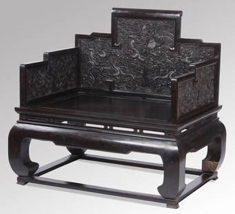 Late 19th c. Chinese carved zitan throne chair: Late 19th century Chinese carved zitan throne armchair, the stepped back and arms ornately embellished with dragons amidst waves and rockwork, the back with a central facing dragon surrounding a flami