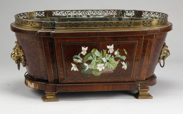 19th c. English rosewood planter: Late 19th century English rosewood and burl wood veneered oval planter, the exterior facades with inset porcelain floral plaques flanked by animal mask handles, surmounted by a gilt bronze gallery and
