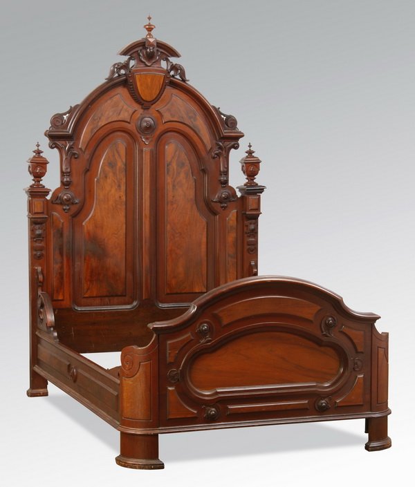 Late 19th c. Renaissance Revival bed: Late 19th century American Renaissance Revival full size bed with raised burl panels and carved scrolling and stylized foliate designs interspersed throughout, the headboard with an arched crest featu