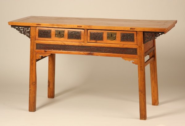 Early 20th c. Chinese altar table: Early 20th century Chinese altar table with two frieze drawers relief carved with floral and foliate designs, the top supported by pierce carved brackets, 34"h x 60"w x 24.5"d.