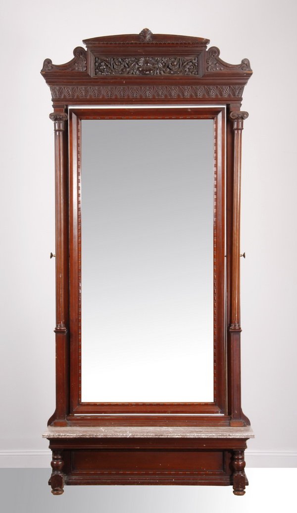 19th c. mahogany pier mirror: Late 19th century carved mahogany pier mirror, the shell crest over a central foliate and floral panel between scrolling ribbons, above a frieze with repeating palmettos, surmounting an adjustable bev