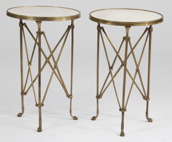 (2) Early 20th c. bronze marble top gueridons: Pair of early 20th century Neoclassical style bronze gueridons with inset white marble tops, raised on straight legs and animal paw feet, with three vertical X-form stretchers, each 26.75"h x 17" diam