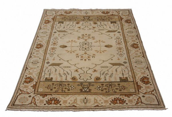Semi-antique hand knotted Turkish rug: Semi-antique hand knotted Turkish rug, with an overall garden design on a cream ground, 109"l x 70"w (9' 1"l x 5' 10"w).