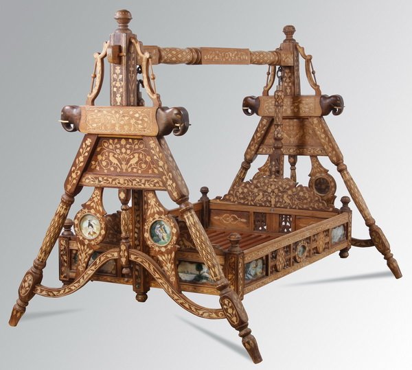 Early 20th c. Indian swinging daybed: Early 20th century Indian swinging daybed with floral marquetry inlay throughout, further adorned with mirrors and painted roundels of figures and landscapes, with the bed frame suspended between two 