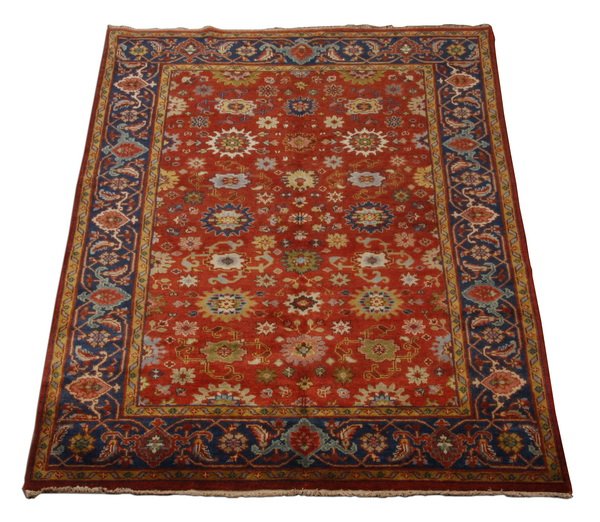 Indo-Persian wool Mahal rug: 20th century Indo-Persian hand knotted wool Mahal area rug, with a stylized floral field framed by a band of alternating shaped lozenges, in shades of blue, green, tan, navy, and red, 111"l x 72"w (9'