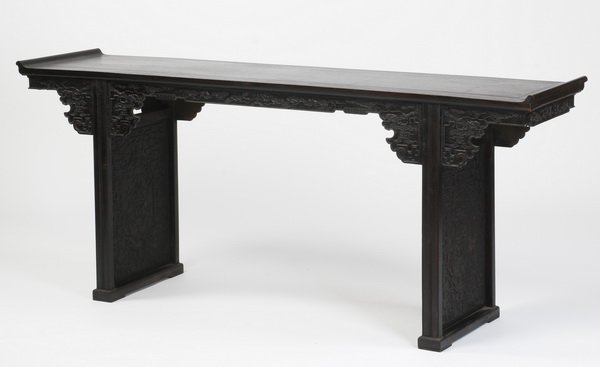 19th c. Chinese carved zitan altar table: Late 19th or early 20th century Chinese carved zitan altar table, the rectangular top with everted ends, surmounting a shaped apron, the sides adorned with auspicious symbols amidst clouds including b
