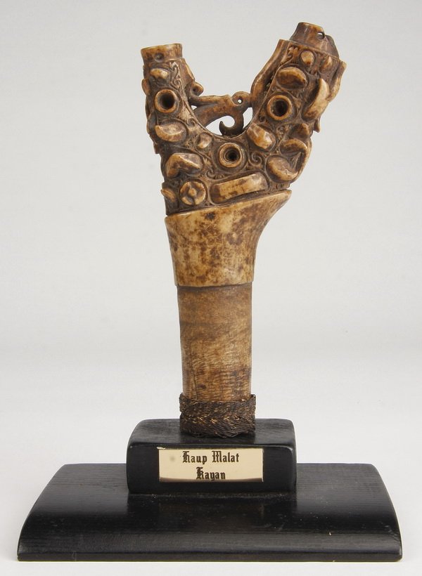 19th c. carved bone sword handle: Mid to late 19th century Haup Malat, Kayan tribe, Bronew, the carved bone handle with a rattan grip, was once attached to a sword known as a "kris", 6"h x 3"w, overall size including stand 7.5"h x 5.2