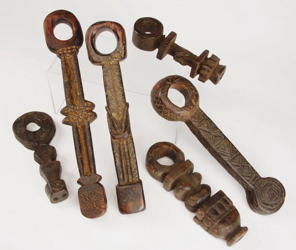 (6) Ghurras, Nepal: Group of six ghurras, Nepal, having religious meaning and practical use as a churning rod holder, the carved wood tool with geometric designs symbolizing the Hindu gods, the largest 14.5"h x 2.5"w.