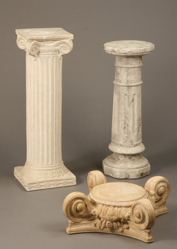 Group of 3 architectural elements: Group of three cast stone architectural elements - (1) pedestal with Doric capital 32"h x 11"w, (1) Corinthian capital 7"h x 15"w, and (1) fluted pedestal 28"h x 10" diam.