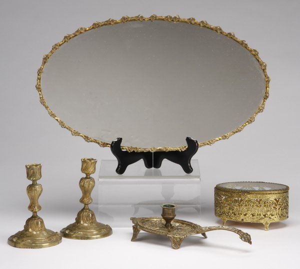 (5) Bronze dressing table articles: Group of five bronze dressing table articles, includes: (1) candleholder 10.75"l, (1) open work filigree oval jewelry box, 3"h x 6"l x 4.5"w, (1) pair of candlesticks, 7"h x 4.5"w, and (1) mirrored tr