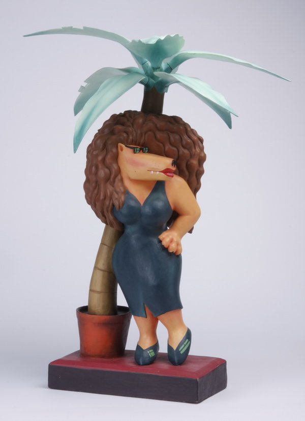 Markus Pierson carved figural sculpture: Circa 1988 limited edition carved wood figural sculpture, #13/250, from "The Coyote Series" by Markus Pierson (American, b. 1961), depicting a standing female coyote posing under a palm tree, raised o