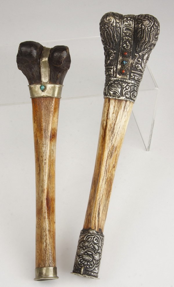 (2) Tibetan bone trumpets, Nepal: Two Tibetan bone trumpets, Nepal, with silvered metal caps on either end encrusted with semi-precious stones, (1) 13"l x 3"w and (1) 11.5"l x 2.75"w.