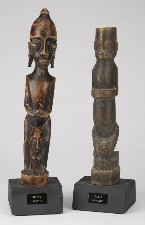(2) Ancestral fetish figures, Sumatra: Two ancestral fetish figures "debata idup", Batak, Sumatra, Indonesia, hand carved wood forms providing spiritual protection, includes: (1) mother figure with twins beneath her legs, 13"h x 2"w, overa