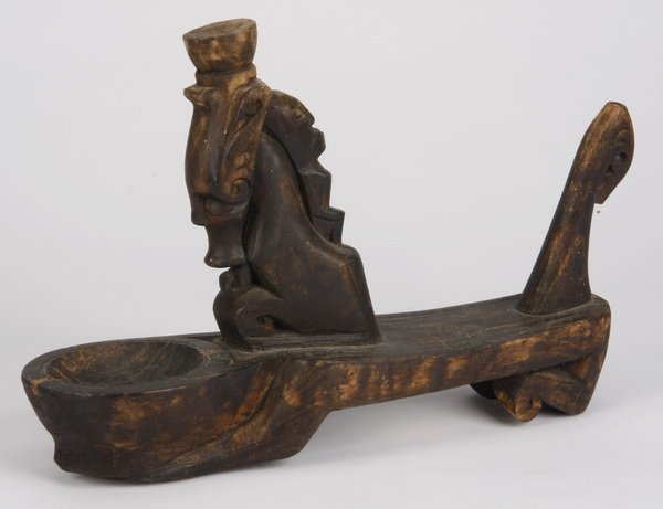Apotropaic medicinal container: Apotropaic medicinal container, Batak, Sumatra, Indonesia, intended to hold "pupuk" during ceremonies, of carved wood formed as a stylized horse, with a figure appearing on the underside, 8"h x 11.5"l