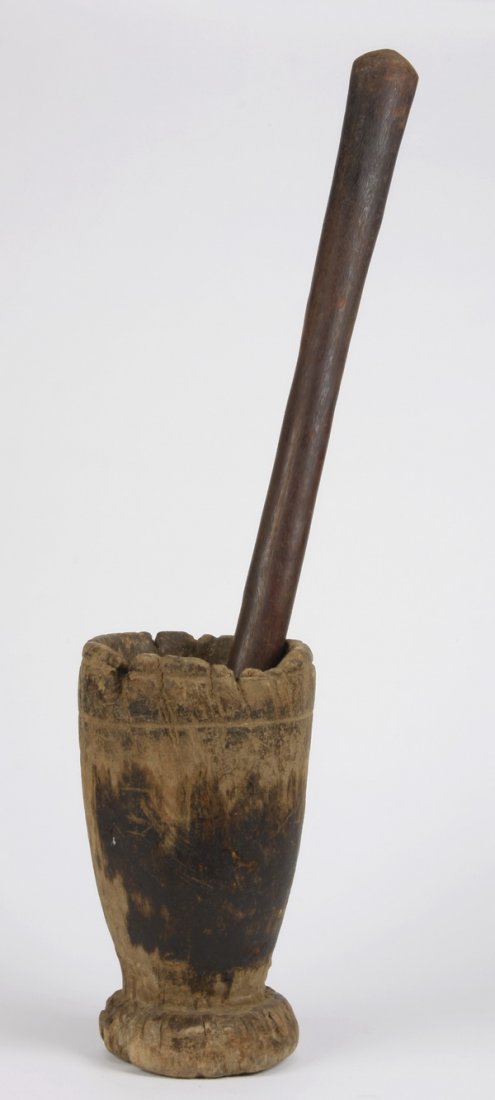 East African mortar and pestle: East African mortar and pestle, most likely from Tanzania, used to grind seeds and vegetables, the mortar 15"h x 8"w, the pestle 35"h x 2"w.