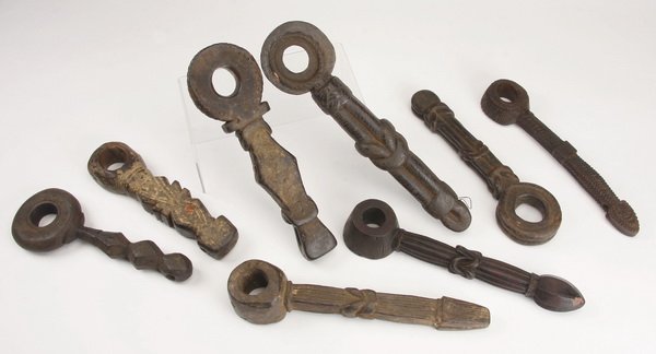 (8) Ghurras, Nepal: Group of eight ghurras, Nepal, having religious meaning and practical use as a churning rod holder, the carved wood tool with geometric designs symbolizing the Hindu gods, the largest 15"h x 4"w.