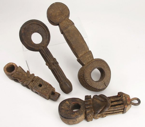 (5) Ghurras, Nepal: Group of five ghurras, Nepal, having religious meaning and practical use as a churning rod holder, the carved wood tool with geometric designs symbolizing the Hindu gods, the tallest 14"h x 4.5"w.