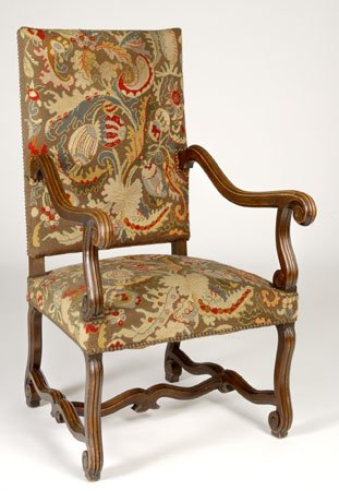 19th c. carved walnut chair w/ needlepoint: 19th century Charles X-style carved walnut armchair with original needlepoint upholstery in moss green, beige and red foliate designs, raised on carved scrolling legs, 45"h.