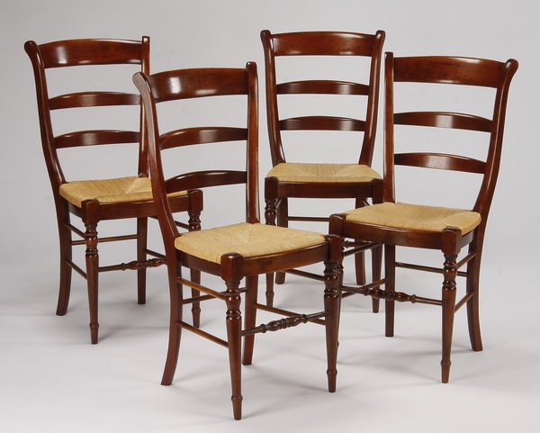 (4) French ladder back chairs: Set of four mid to late 20th century French mahogany ladder back chairs, with curved backrests and woven rush seats, 36"h x 17.5"w x 19"d.