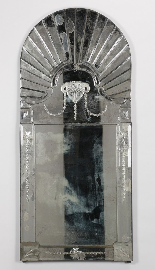 69"h Venetian style mercury glass mirror: 20th century Venetian style beveled mercury glass mirror with a sunburst surmounting a central wheel cut ram's head, 68.5"h x 30"w.