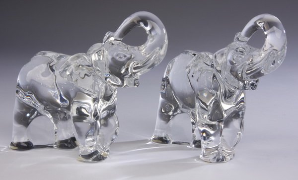 (2) Baccarat crystal elephants, marked: Pair of Baccarat cut crystal standing figures of elephants with their trunks raised, maker marked, each 6.75"h x 3"w x 6.5"d.