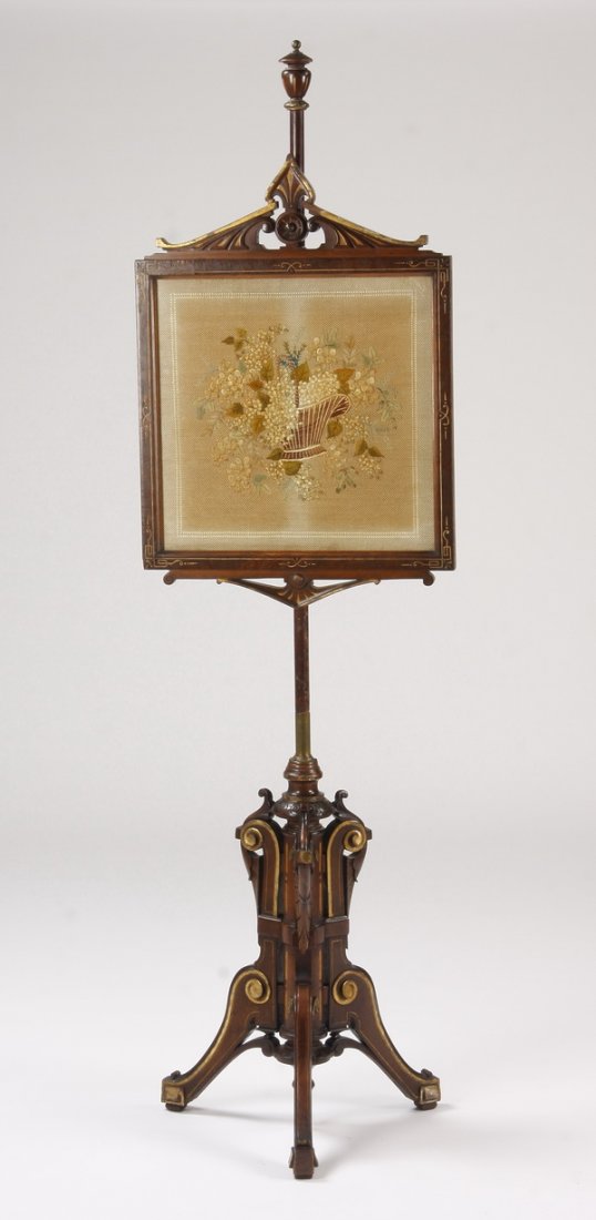 19th c. Renaissance Revival fire screen: Late 19th century American Renaissance Revival fire screen, the carved mahogany stand with an adjustable framed and embroidered panel depicting a flower filled basket, on a carved scrolling tripod bas