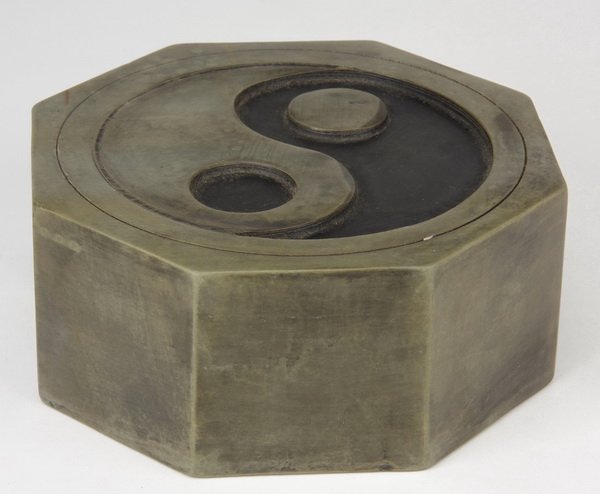 Early 20th c. Chinese inkstone: Early 20th century Chinese octagonal-shaped inkstone, carved with a yin yang symbol on one side and inscribed on the reverse, 2.5"h x 6"w x 6"d.