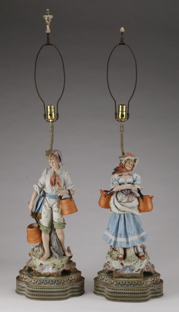 (2) Old Paris style figural lamps: Pair of Old Paris Style porcelain figural lamps of a rural Bavarian man and woman in traditional garb carrying baskets, each on an openwork gold filigree base, 43.5"h x 12"w x 8"d.
