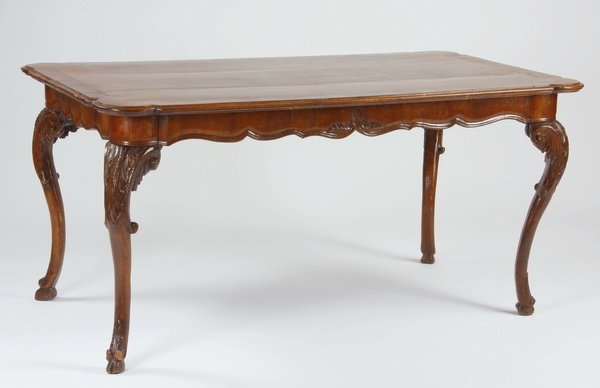 19th c. French carved walnut dining table: Early to mid 19th century French Provincial carved walnut dining table, the shaped top surmounting cabriole legs with scrolling acanthus details and ending in hoof feet, 32"h x 64"l x 35"w.