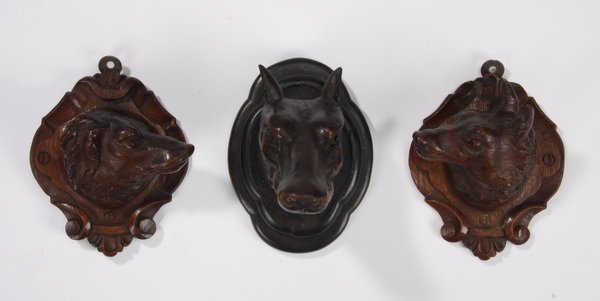 (3) Black Forest carved oak mounts: Goruping of three late 19th century carved oak Black Forest animal head mounts, includes: (2) mirror image carvings of hounds, 7.5"h x 6"w x 3.5"d, and (1) carving of a wolf, 7.5"h x 5.5"w x 7"d.