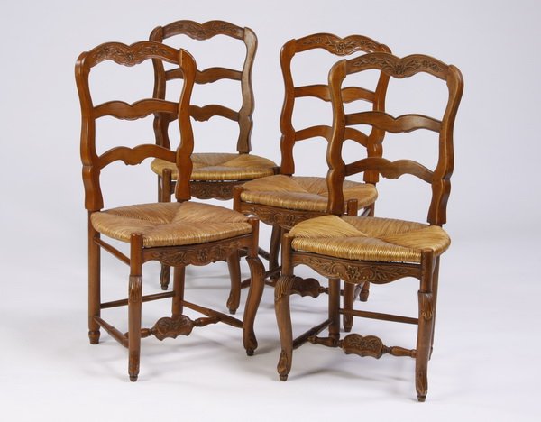 (4) French Provincial style chairs: Set of four 20th century French Provincial style carved walnut side chairs, each with a foliate crest above a ladder back over a woven rush seat, raised on cabriole legs, joined by an H-shaped stretch