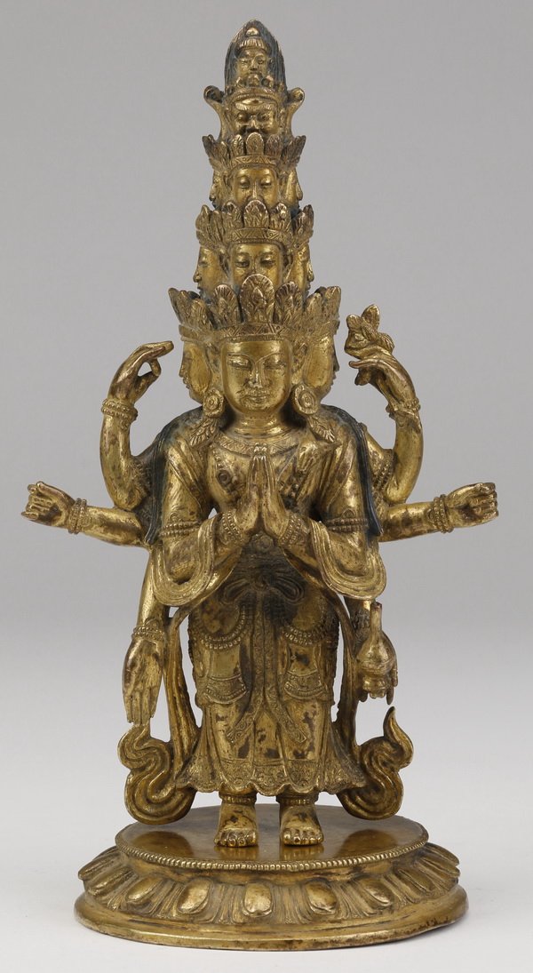 19th c.Tibetan gilt bronze Bodhisattva figure: Late 19th or early 20th century Sino-Tibetan gilt bronze figure of Avalokiteshvara, the standing Bodhisattva with eleven faces arranged in tiers, having two principle hands in anjalimudra with six add