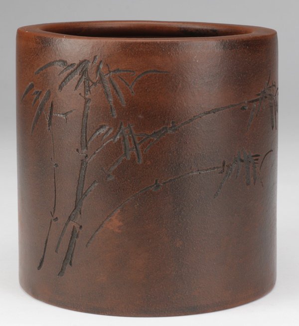 Early 20th c. Chinese Yizing zisha brush pot: Early 20th century Chinese Yixing stoneware brush pot, the zisha clay of cylindrical form with incised bamboo on one side, with the reverse inscribed, the base with impressed seal mark, 5.5"h x 5.25" 