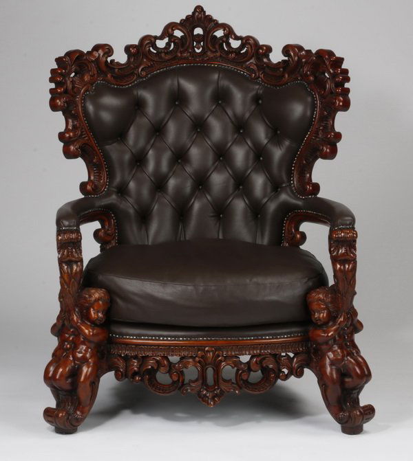 Oversized Rococo inspired armchair: Oversized 20th century Rococo inspired armchair, upholstered in brown leather with nail head trim, the curved pierce carved backrest and matching apron with elaborate acanthus form c-scrolls, supporte