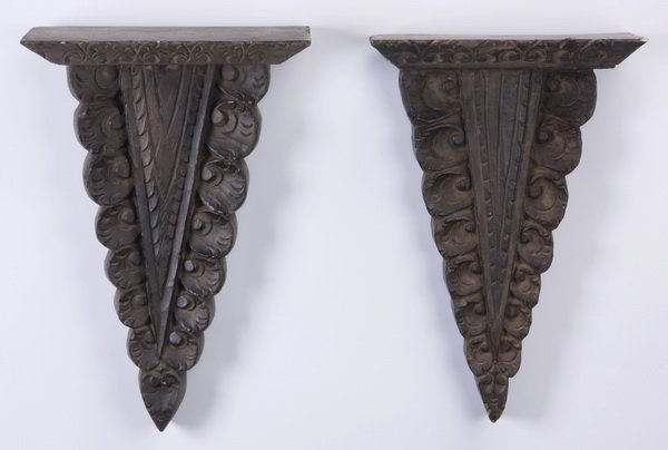 (2) Hand carved wood wall brackets: Pair of hand carved wood wall brackets, the rectangular shelf surmounting a triangular support with C-scroll decoration, each 19"h x 13"w x 6"d.
