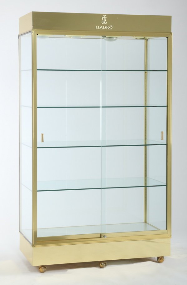 Brass and glass display case: Brass and glass display case with sliding doors, five interior glass shelves, four interior recessed lights, and casters for easy moving, 83.5"h x 48"l x 24"d.