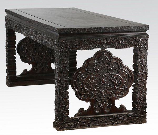 Late 19th century Chinese zitan altar table: Late 19th or early 20th century Chinese zitan altar table, ornately carved in low relief with auspicious symbols, the rectangular top having cloud-form edges, over the apron adorned with flying bats a