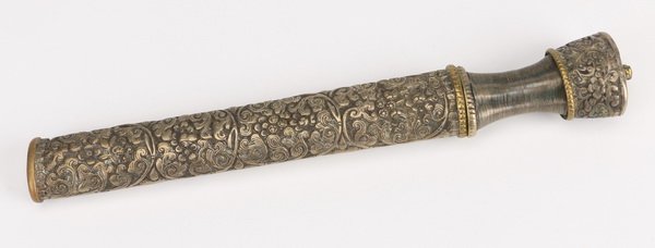 19th c. Tibetan silver dagger and scabbard: 19th century Tibetan silver dagger inside a silver scabbard with foliate decoration, a ribbed handle, and gilt accents throughout, 19.5" long x 1.5"w.