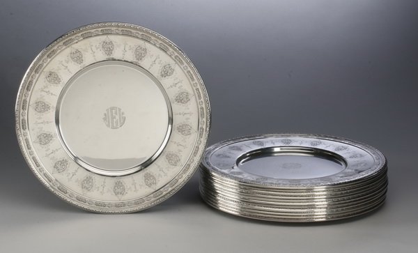 (12) Towle sterling silver chargers, marked: Set of 12 Towle sterling silver chargers, in the Louis XIV pattern with floral and foliate decoration, monogramed JLE in the center, maker marked, each 11" diameter.